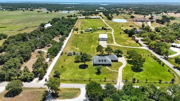 an aerial view of a residential houses with outdoor space