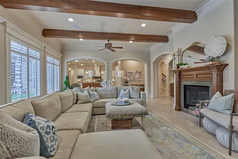 a living room with fireplace furniture and a large window