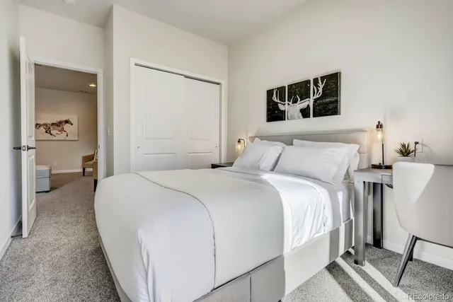 a bedroom with a large bed and a window