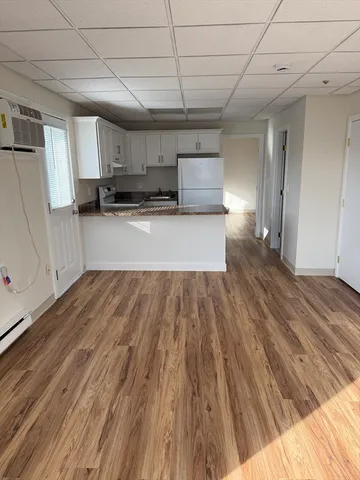 a view of a room with wooden floor and cabinet