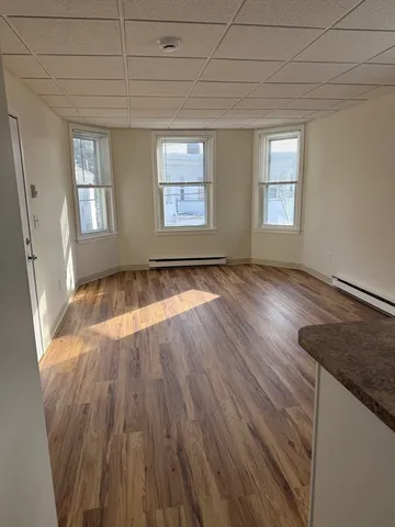 a view of a room with window and wooden floor