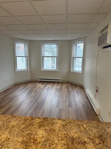 a view of wooden floor and windows in a room