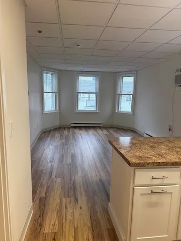 a view of wooden floor and windows in a room