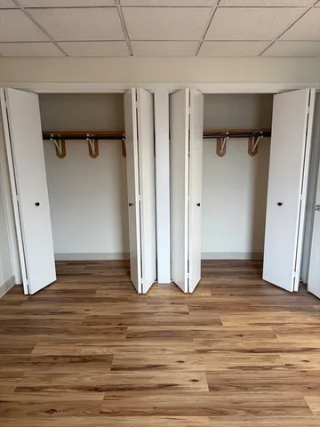 a view of a room with wooden floor