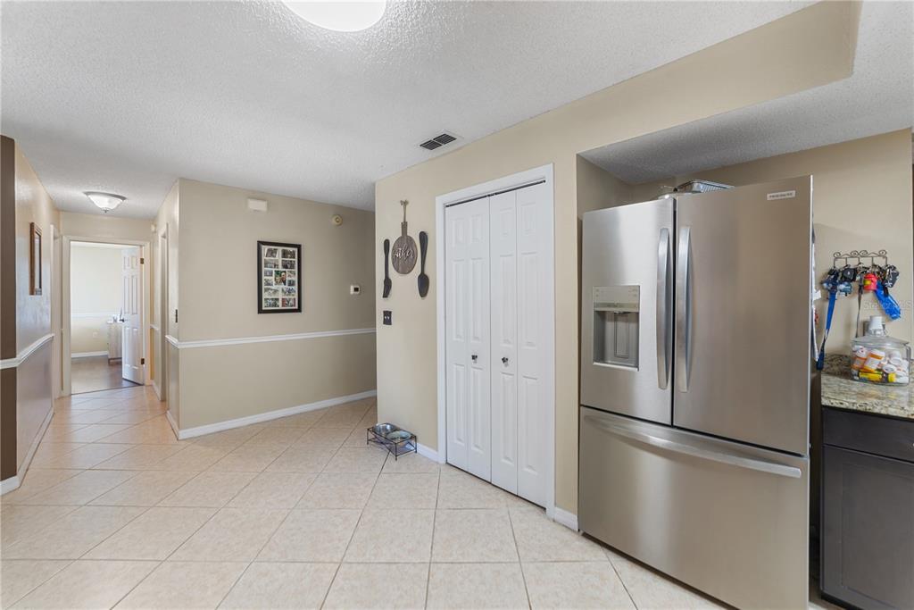 8715 Huntsman Lane Port Richey, FL 34668 - Photo 10 of 54 a kitchen with stainless steel appliances a refrigerator and a stove top oven