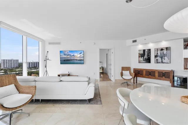 a spacious bedroom with a bed a couch and a table in it