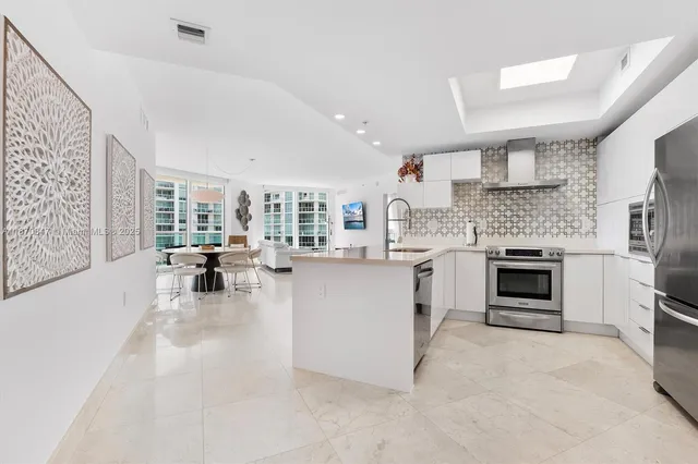 a kitchen with a stove a faucet and chairs