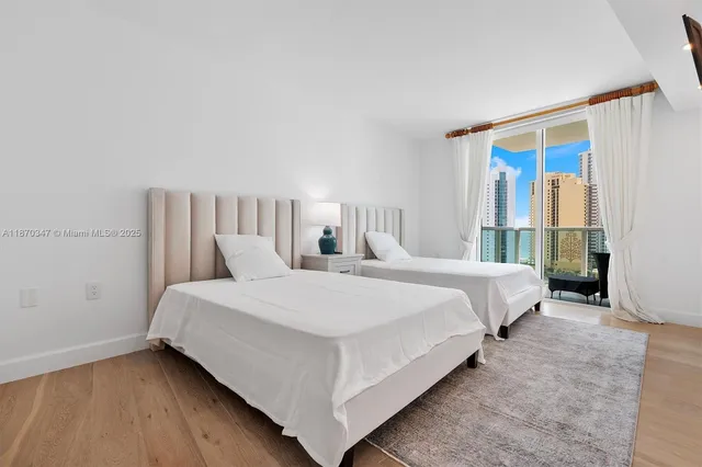 a large bed sitting in a bedroom and a table