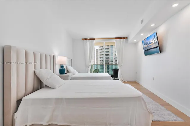 a large white bed in a white room