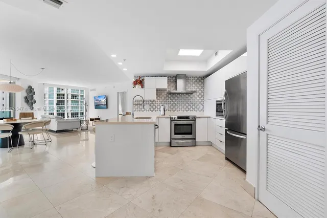 a large kitchen with cabinets and stainless steel appliances