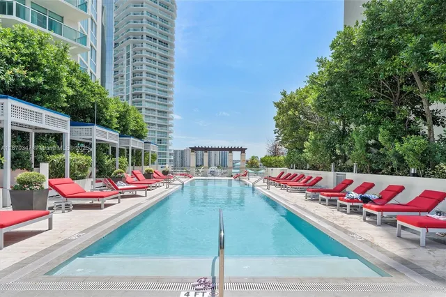 a view of an outdoor space with lounge chairs