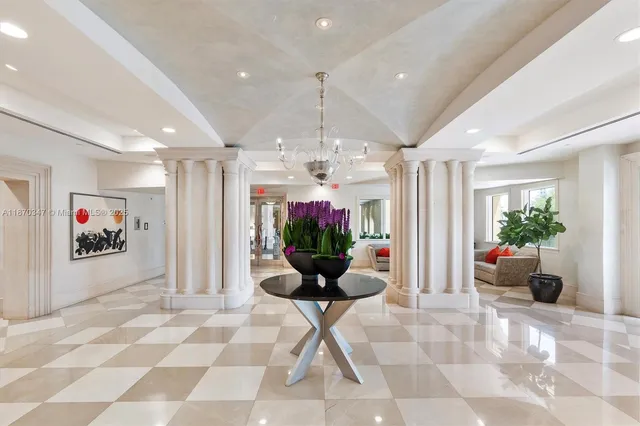 a lobby with furniture and a potted plant