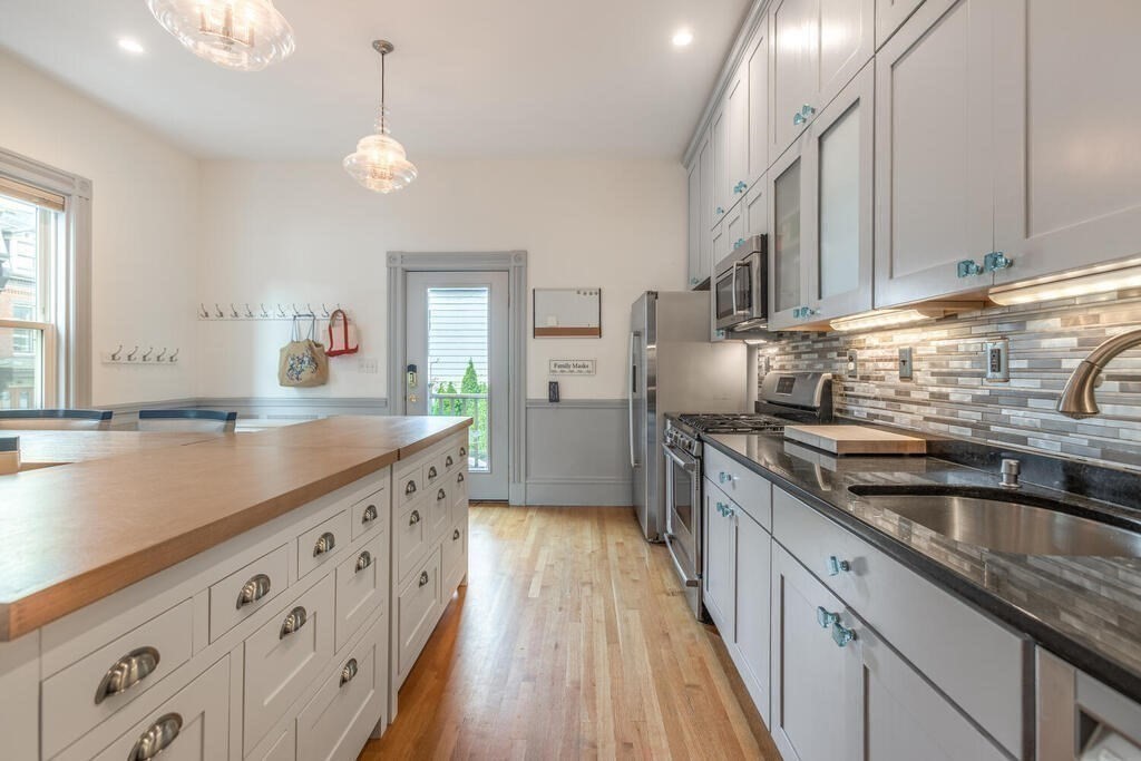 45 M Street Boston, MA 02127 - Photo 11 of 42 a kitchen with stainless steel appliances granite countertop a sink and a stove