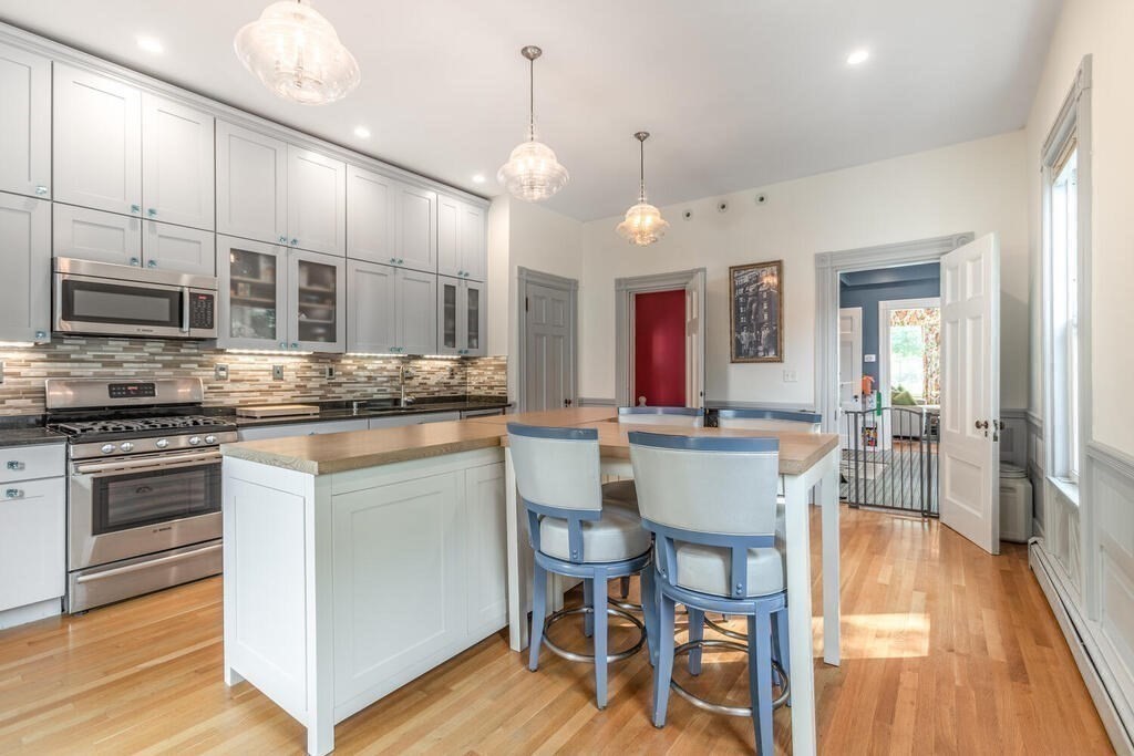 45 M Street Boston, MA 02127 - Photo 13 of 42 a large kitchen with a table and chairs