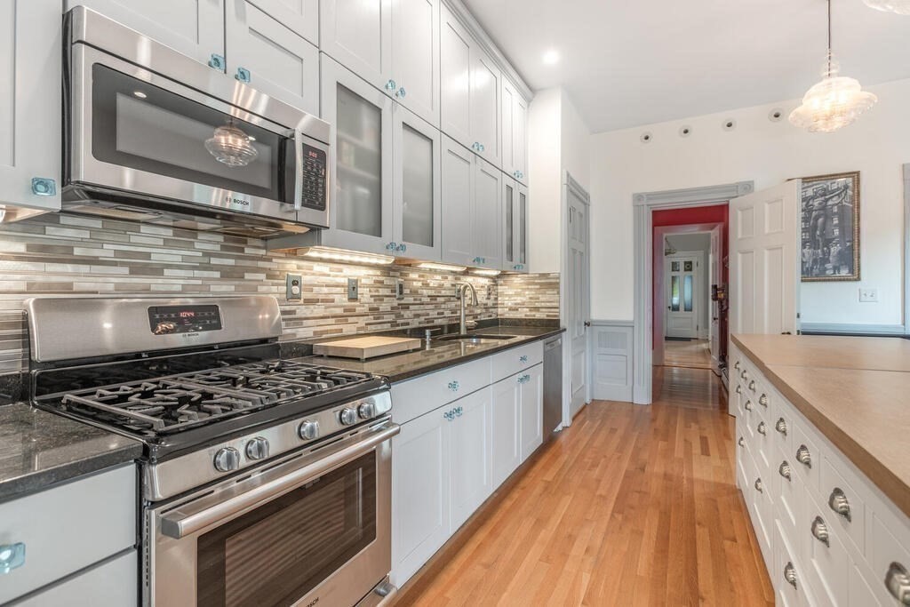 45 M Street Boston, MA 02127 - Photo 14 of 42 a kitchen with stainless steel appliances granite countertop wooden cabinets stove top oven and sink