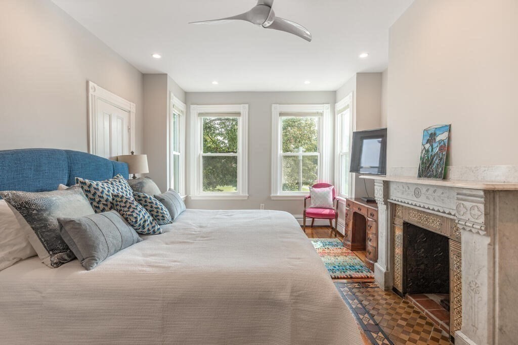 45 M Street Boston, MA 02127 - Photo 15 of 42 a bedroom with a bed a fireplace and windows