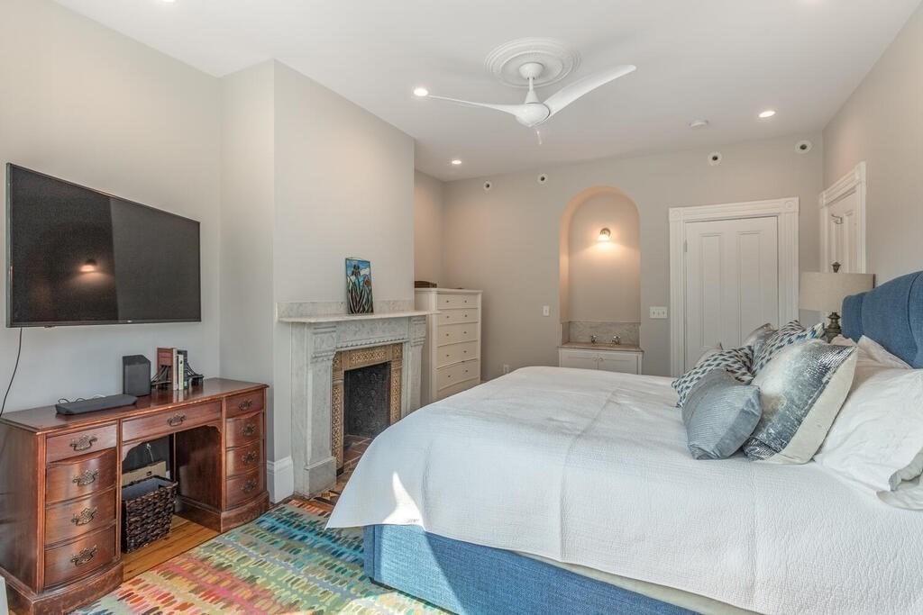 45 M Street Boston, MA 02127 - Photo 16 of 42 a spacious bedroom with a bed and a flat screen tv