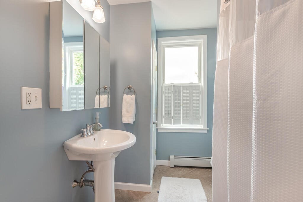 45 M Street Boston, MA 02127 - Photo 19 of 42 a bathroom with a sink toilet and a mirror