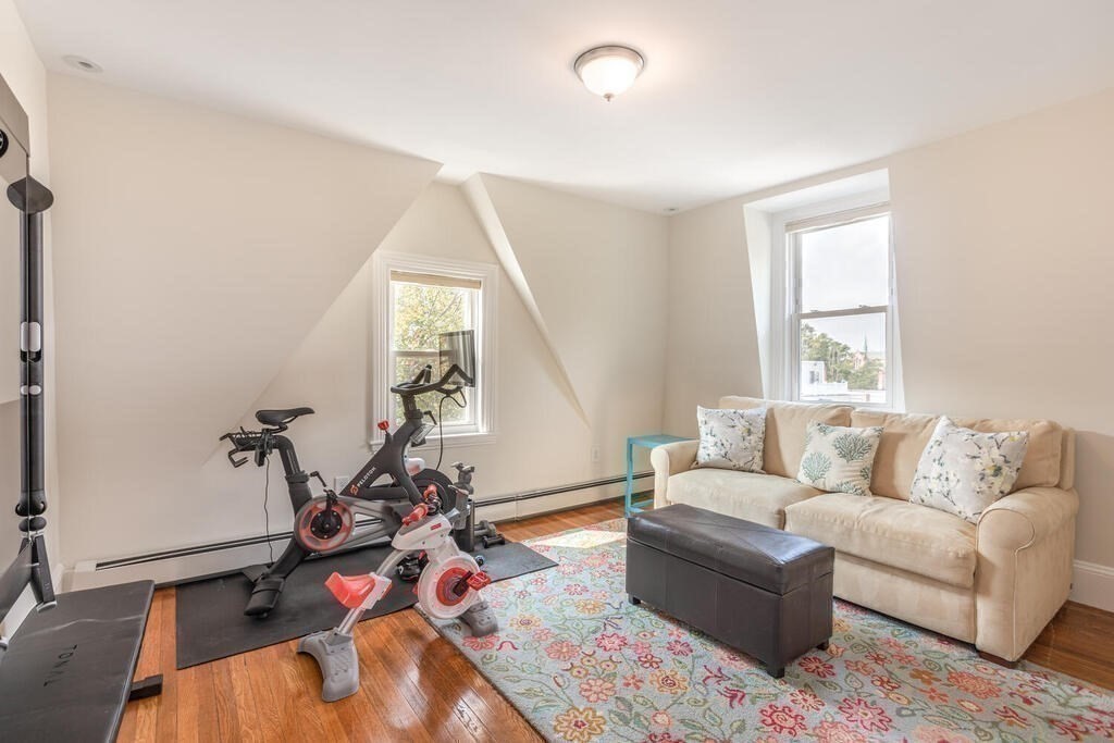 45 M Street Boston, MA 02127 - Photo 22 of 42 a living room with furniture a window and gym cycle