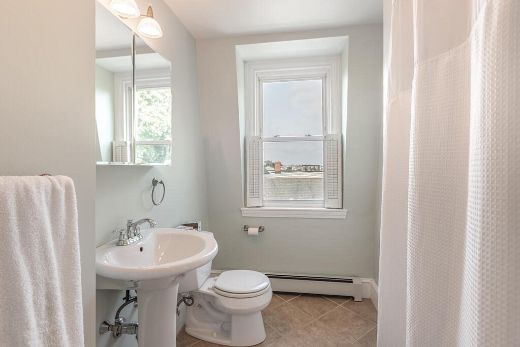 45 M Street Boston, MA 02127 - Photo 23 of 42 a bathroom with a sink a toilet and a window