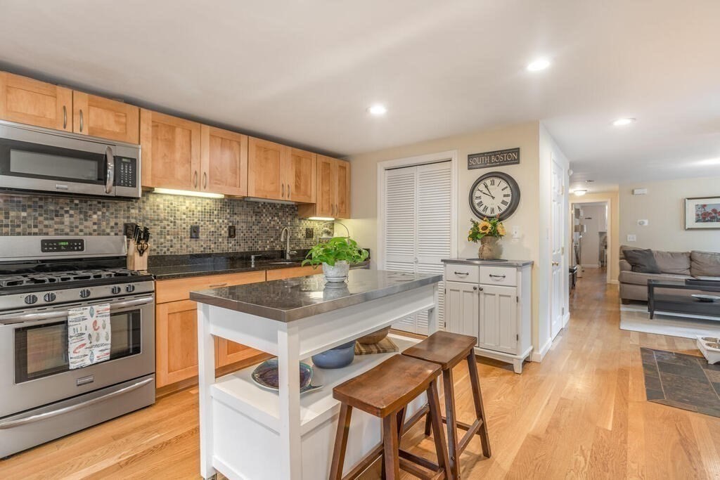 45 M Street Boston, MA 02127 - Photo 28 of 42 a kitchen with stainless steel appliances granite countertop a stove top oven a sink a counter space and cabinets
