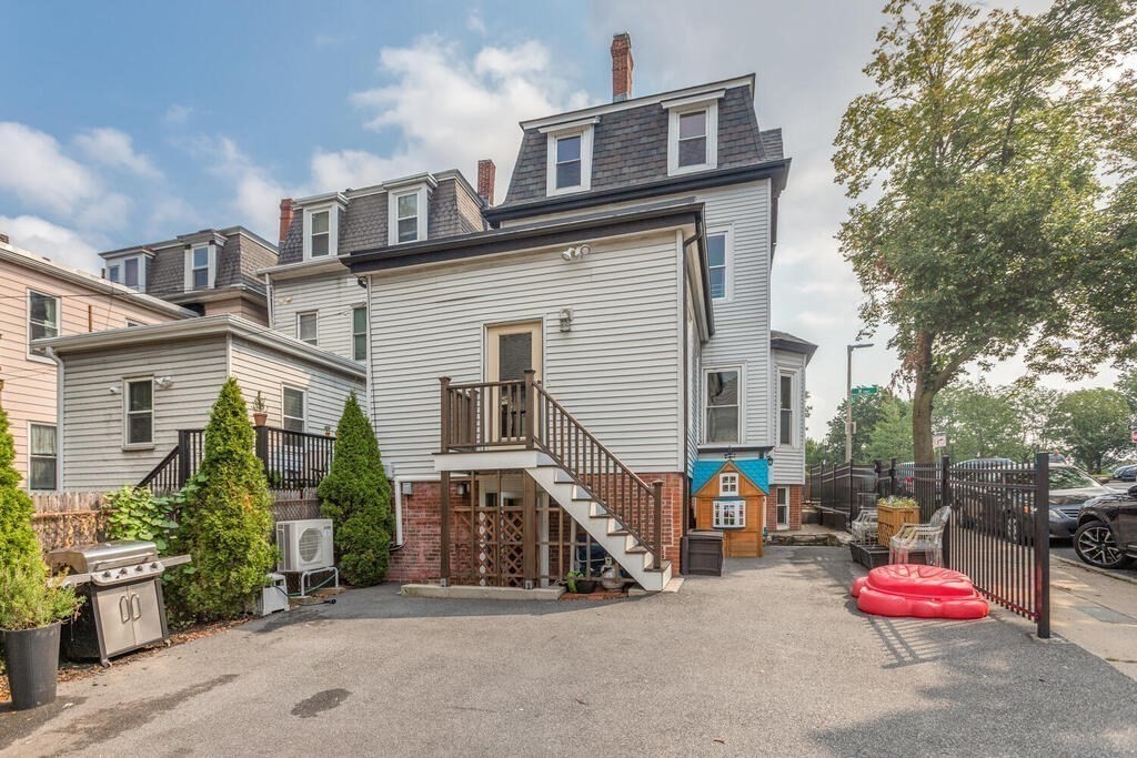 45 M Street Boston, MA 02127 - Photo 34 of 42 a view of a house with a cars park side of a road
