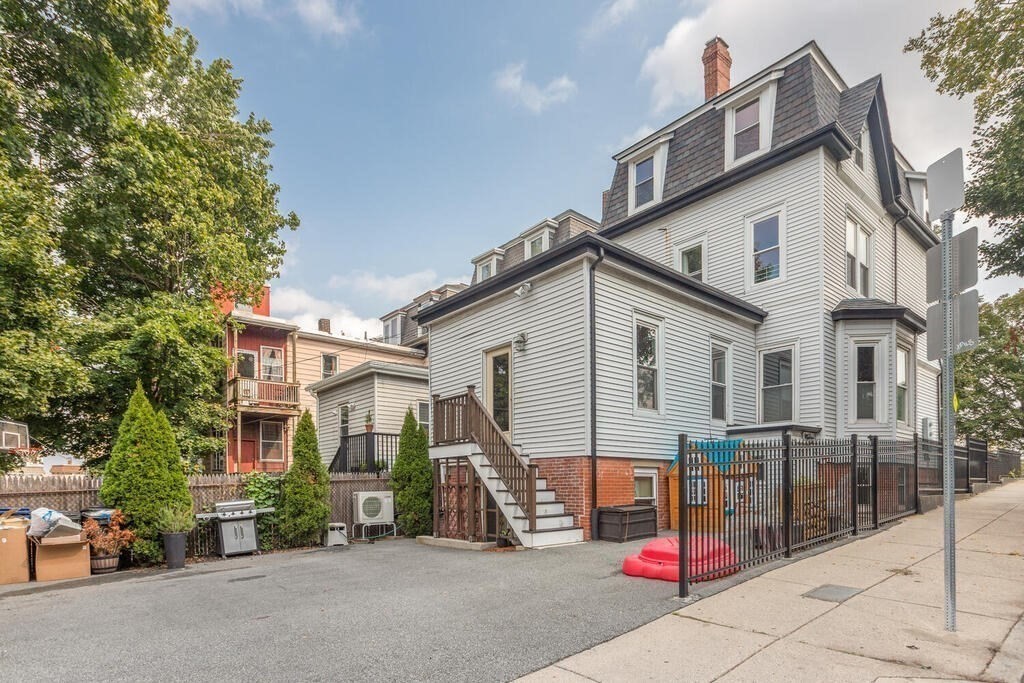 45 M Street Boston, MA 02127 - Photo 35 of 42 a view of a house with a patio and a wooden fence