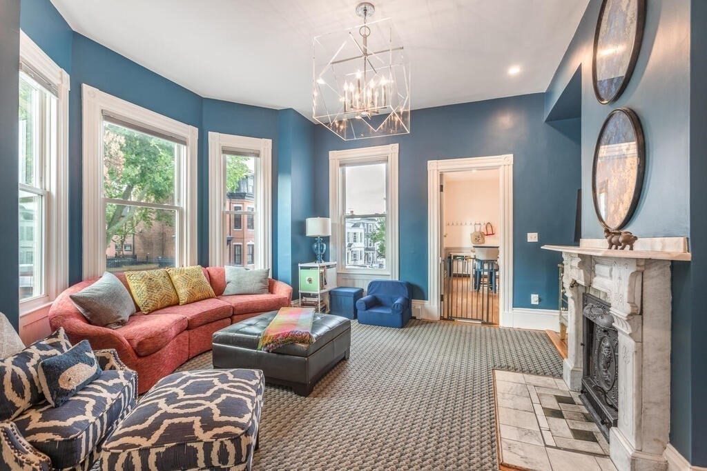 45 M Street Boston, MA 02127 - Photo 9 of 42 a living room with furniture a fireplace and a chandelier