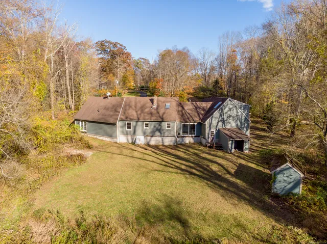a view of a house with a yard covered with snow