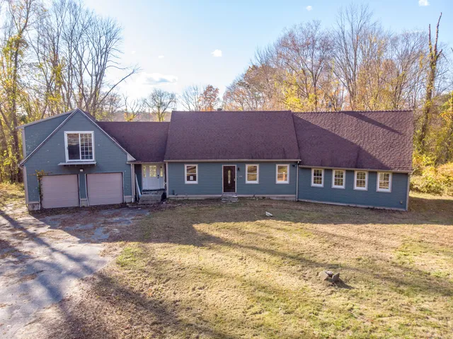 a view of a house with a yard covered in snow