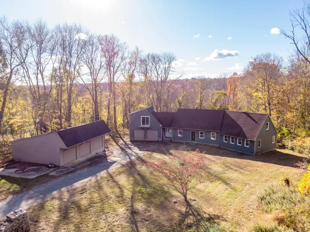 a view of house with outdoor space and sitting area
