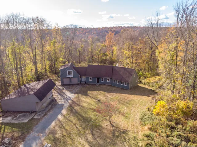 a view of a house with a yard and sitting area