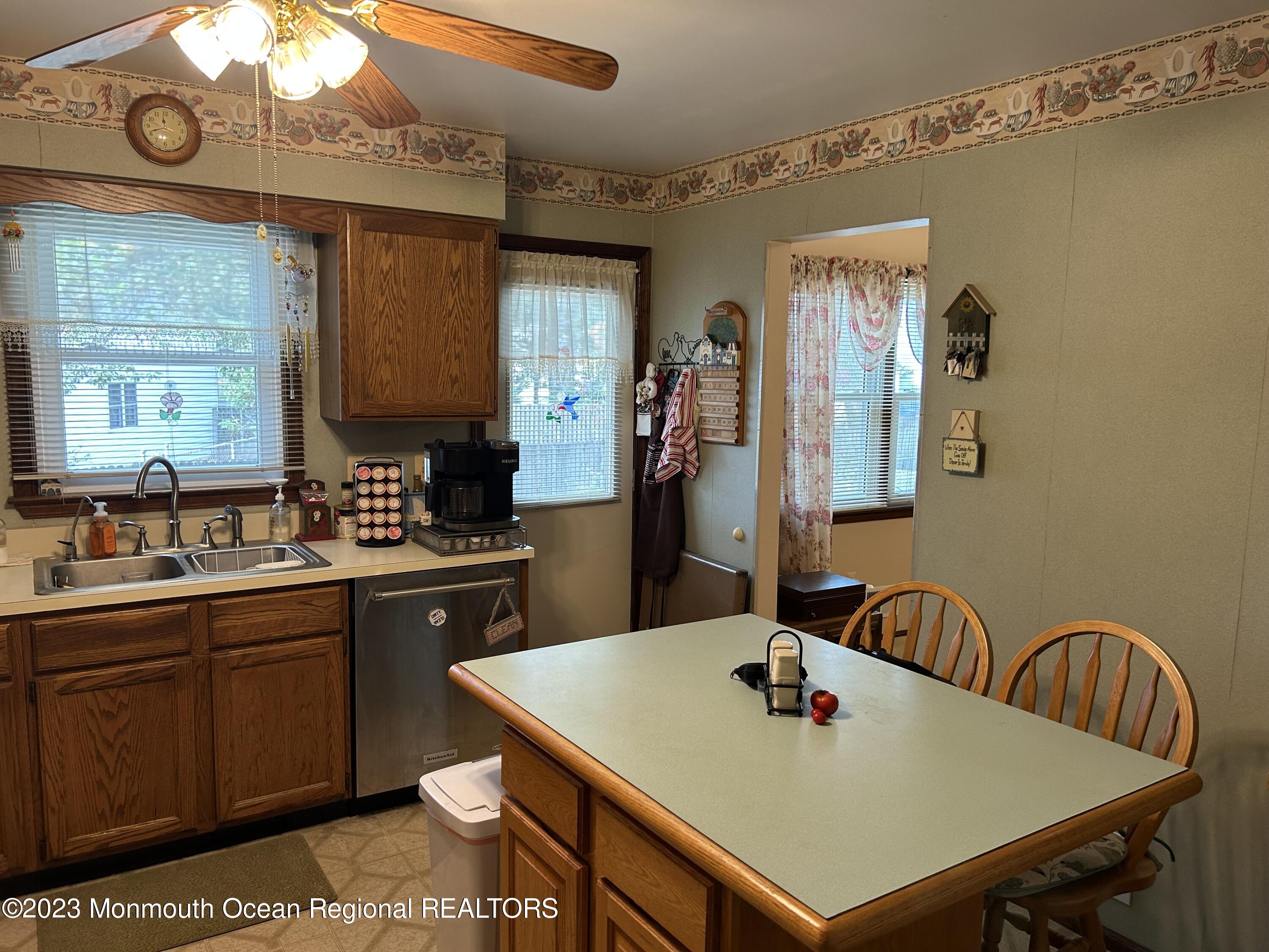 1635 Burrsville Road Brick, NJ 08724 - Photo 9 of 15 a kitchen with stainless steel appliances a sink a table and chairs