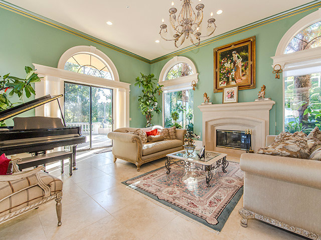 150 New Place Road Hillsborough, CA 94010 - Photo 5 of 25 a living room with furniture a fireplace and a chandelier