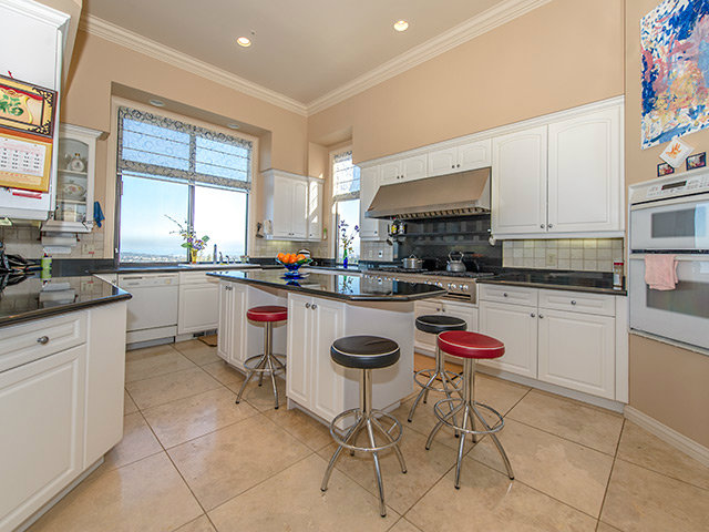 150 New Place Road Hillsborough, CA 94010 - Photo 10 of 25 a kitchen with stainless steel appliances kitchen island granite countertop a sink and cabinets