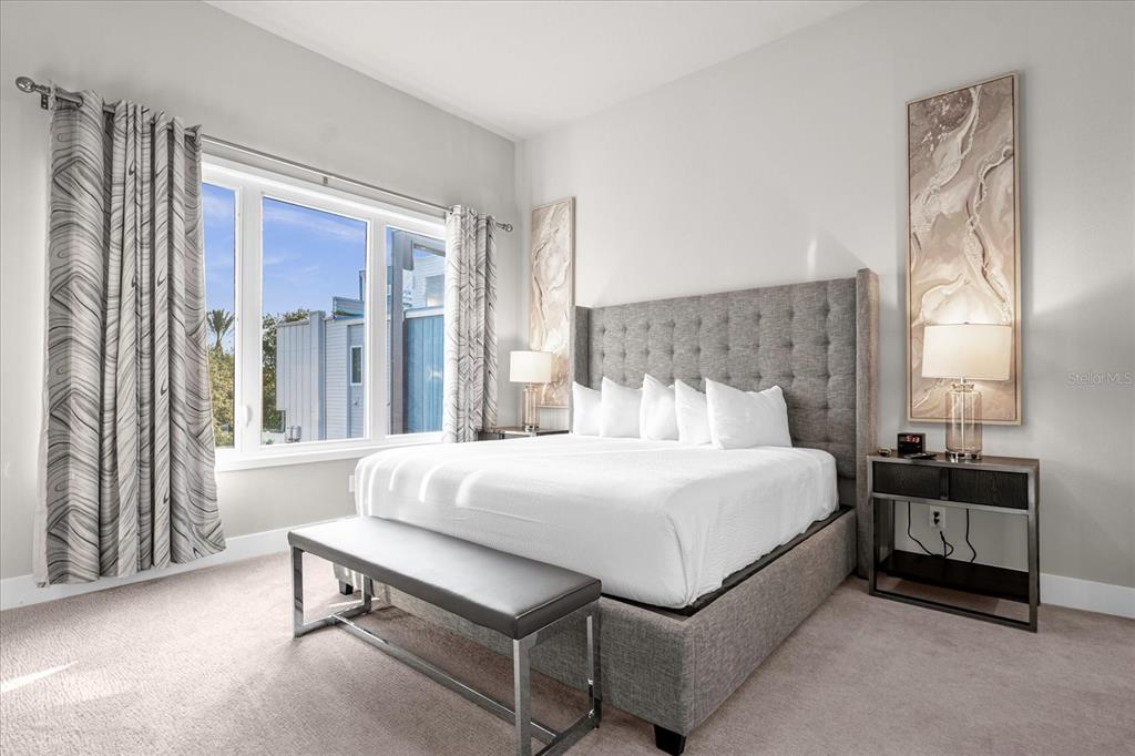 7770 Sandy Ridge Drive, Unit 227 Reunion, FL 34747 - Photo 11 of 33 a bedroom with a bed and a night stand