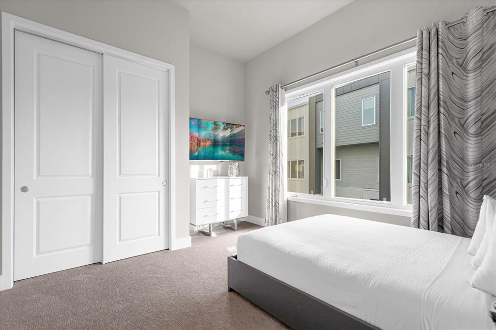 7770 Sandy Ridge Drive, Unit 227 Reunion, FL 34747 - Photo 16 of 33 a spacious bedroom with a bed and a window