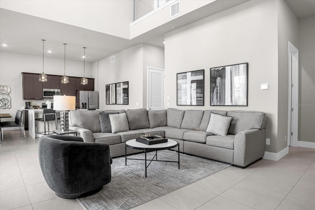 7770 Sandy Ridge Drive, Unit 227 Reunion, FL 34747 - Photo 4 of 33 a living room with furniture and view of kitchen