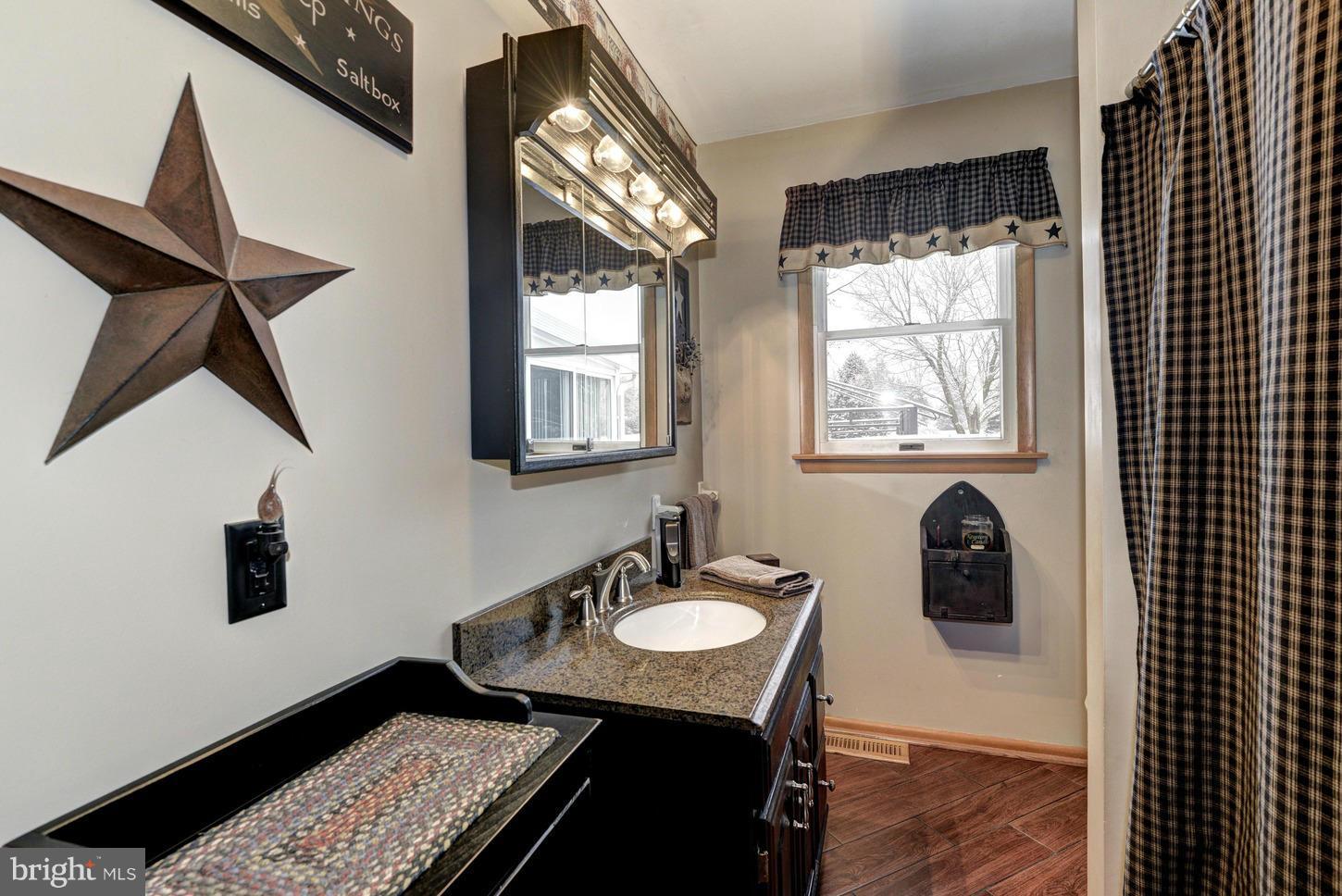 4115 Baptist Road Taneytown, MD 21787 - Photo 14 of 30 a bathroom with a sink a mirror and a window