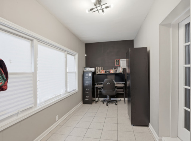 7118 South Indiana Avenue Chicago, IL 60619 - Photo 11 of 22 a view of a workspace with furniture and a window