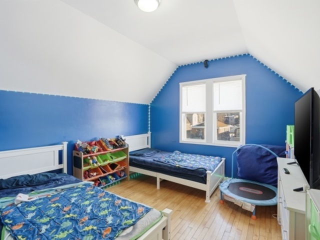 7118 South Indiana Avenue Chicago, IL 60619 - Photo 14 of 22 a bedroom with furniture and a wooden floor