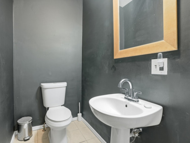 7118 South Indiana Avenue Chicago, IL 60619 - Photo 16 of 22 a bathroom with a toilet sink and mirror