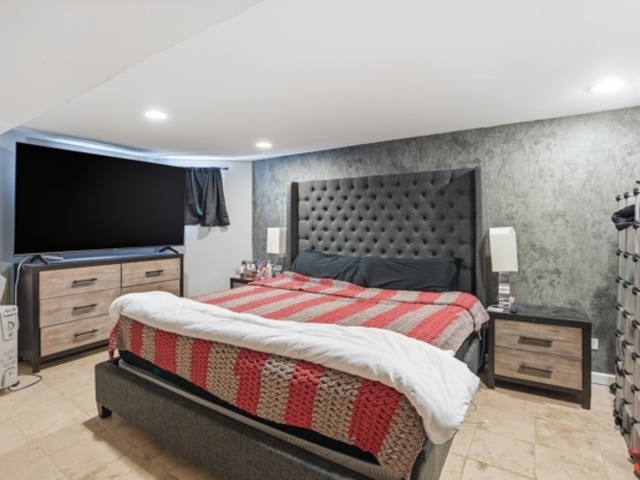 7118 South Indiana Avenue Chicago, IL 60619 - Photo 19 of 22 a bedroom with a bed and a flat screen tv