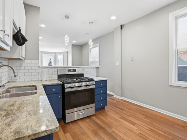 7118 South Indiana Avenue Chicago, IL 60619 - Photo 6 of 22 a kitchen with stainless steel appliances granite countertop a stove a sink and a refrigerator