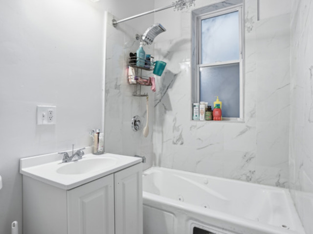 7118 South Indiana Avenue Chicago, IL 60619 - Photo 10 of 22 a bathroom with a sink and a bathtub
