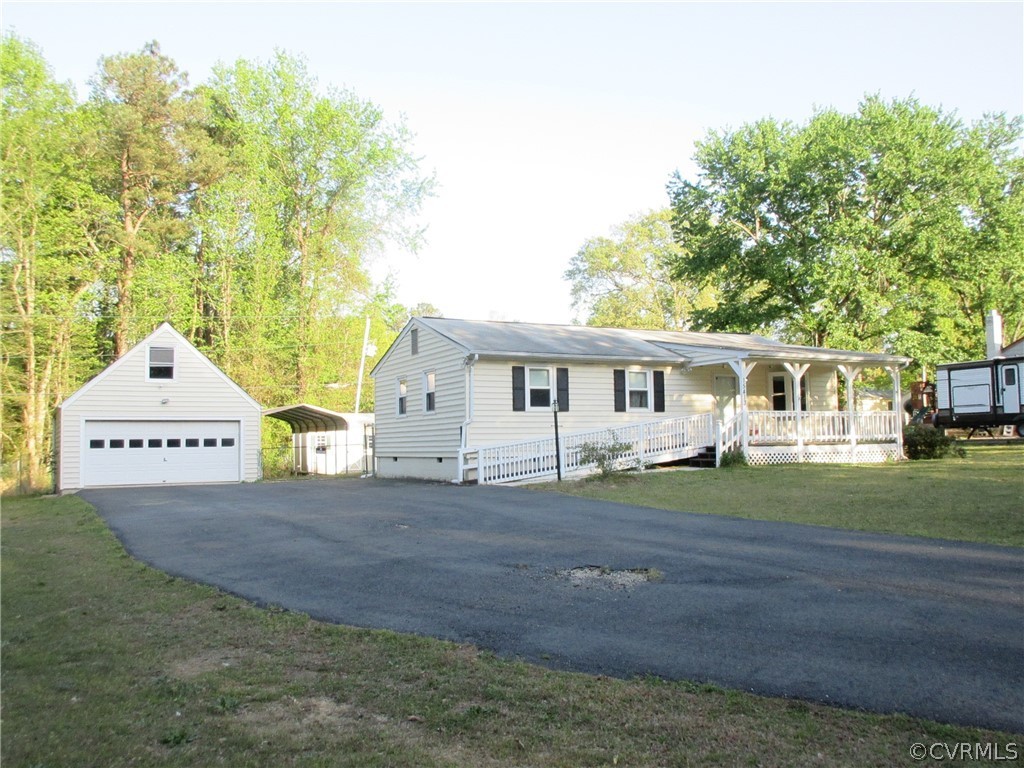 15413 Saddlebrook Road Chesterfield, VA 23838 - Photo 2 of 39 a front view of a house with a garden and trees
