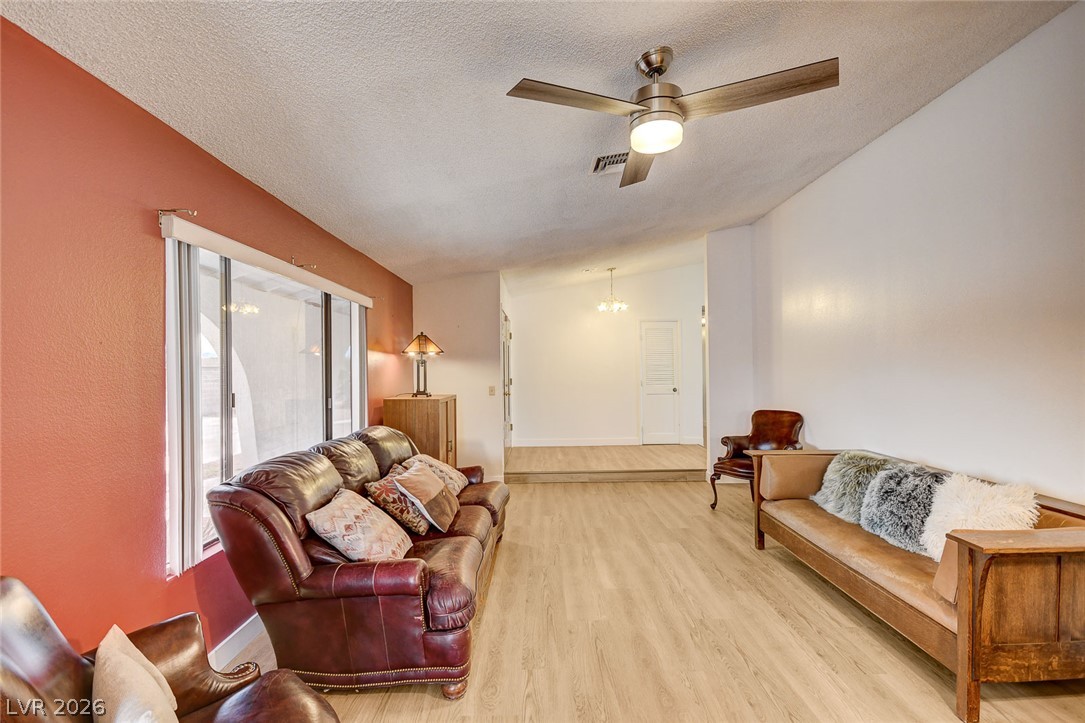 1401 Sharon Road Las Vegas, NV 89106 - Photo 24 of 73 Smooth wood floors and high vaulted ceilings define this inviting living area.