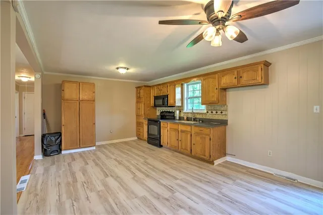 a kitchen with stainless steel appliances granite countertop a refrigerator and a sink