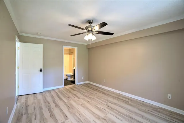 a view of a big room with closet and a ceiling fan