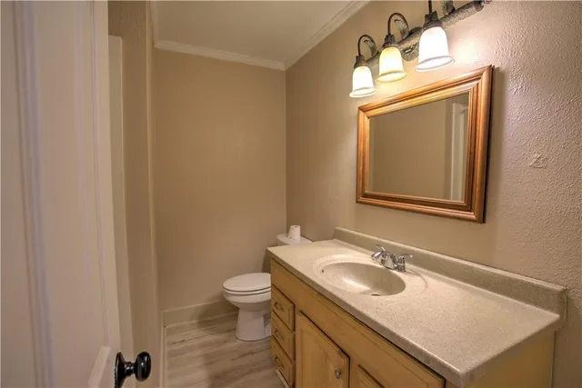 a bathroom with a sink toilet and mirror